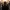 Man holding head in panic as blurred crowd rushes around him in a busy city scene