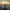 Man standing on a high ledge overlooking a misty city at sunrise, symbolizing uncertainty and hope