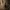 Isolated chess pawn inside a circle, surrounded by blurred pieces in low light