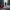 Broken red heart on a wet road, blurred figure walking away in the distance