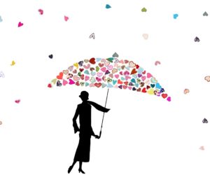 Silhouetted figure holds an umbrella formed from many small hearts
