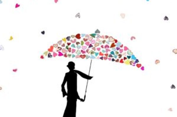 Silhouetted figure holds an umbrella formed from many small hearts