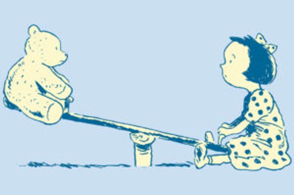 A child sits on one end of a seesaw opposite a teddy bear
