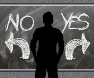 Silhouette standing between NO and YES with arrows pointing in opposite directions