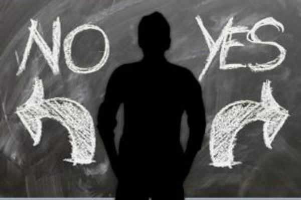 Silhouette standing between NO and YES with arrows pointing in opposite directions