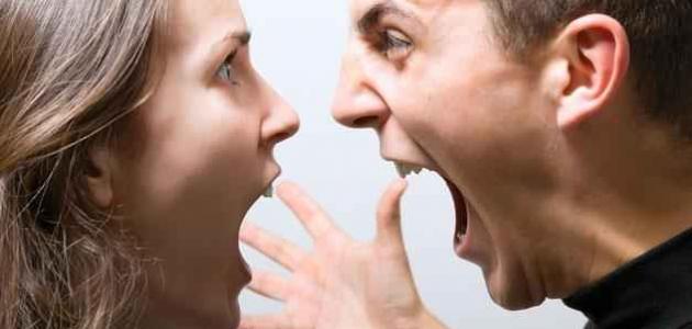 Two people face each other at close range with open mouths and a raised hand