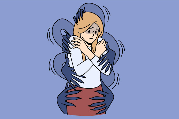 Person hugging themselves while shadowy hands surround their body