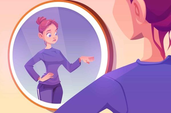 Person faces a round mirror as their reflection points back at them