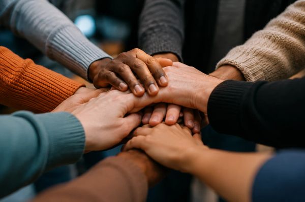 Group of people holding hands showing support and determination