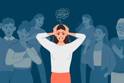 Person holds their head while standing amid a group of people