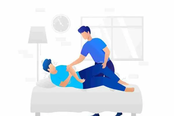 One person kneels beside another lying on a sofa