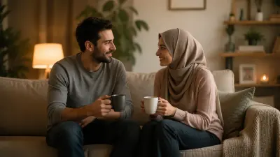 Couple smiling on a cozy sofa, holding mugs in warm, softly lit living room