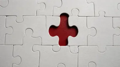 Missing puzzle piece reveals red center beneath white pieces symbolizing love’s gap