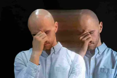 Two overlapping views of a bald adult pressing a hand to their face