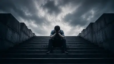 A lone person sits on dark steps under stormy skies, head in hands, overwhelmed and heavy.