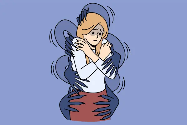 Person hugging themselves while shadowy hands surround their body