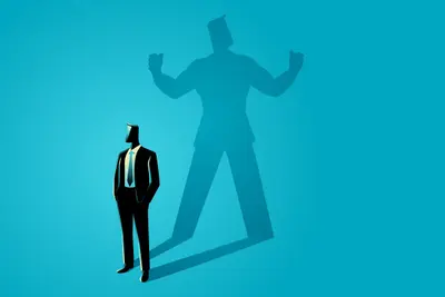 A suited figure stands before an oversized shadow flexing both arms