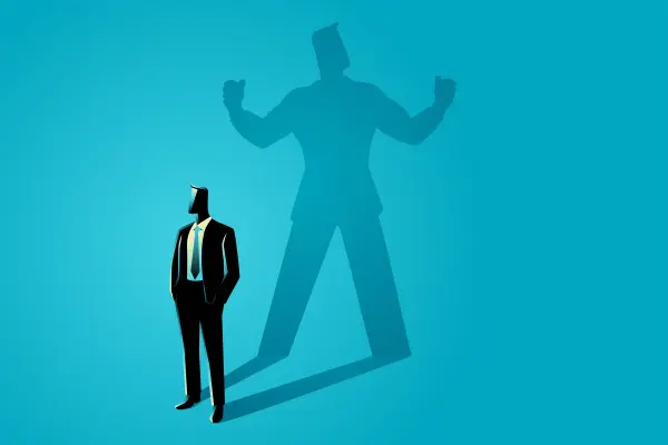 A suited figure stands before an oversized shadow flexing both arms
