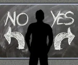 Silhouette standing between NO and YES with arrows pointing in opposite directions